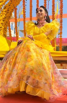 a woman in a yellow dress sitting on a bench