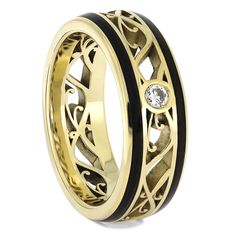 This amazing solid gold wedding band features a swirling center framed by two sleek and symmetrical inlays of African blackwood. A single, sparkling diamond is flush set among the polished gold. RING LAYOUTRing Width: 7.5 mmRing Sleeve: 10K Yellow GoldRing Profile: RoundRing Finish: Polished0.75 mm 10K Yellow Gold1 mm African Blackwood4 mm 10K Yellow Gold1 mm African Blackwood0.75 mm 10K Yellow Gold Diamond (Qty: 1) Shape/Size: Round, 3 mmQuality: SI1, G-HSetting: Flush Art Nouveau Wedding Band, Art Nouveau Wedding, Solid Gold Wedding Band, Ring Armor, Nouveau Wedding, Filigree Wedding Band, Art Nouveau Weddings, Wedding Band Diamond, Inlay Jewelry