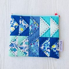 a small blue and white patchwork pouch