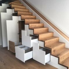 the stairs are made of wood and white boxes