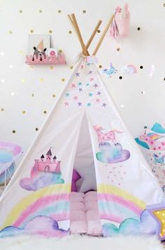 a child's teepee with unicorns and stars on the wall next to it