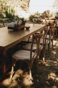 a long wooden table with many chairs around it