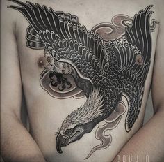 a man with an eagle tattoo on his chest