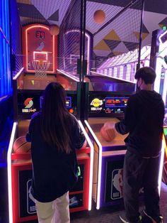 two people playing basketball in an indoor arcade