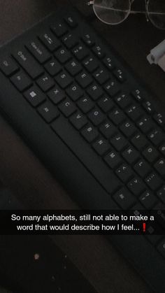 a computer keyboard sitting on top of a desk next to a cup of coffee and glasses