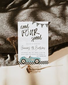 a car themed birthday party is set up on top of a bed with a card