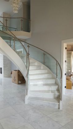 there is a white staircase in the middle of this room with marble floors and walls