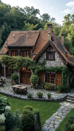 a stone house with lots of greenery around it