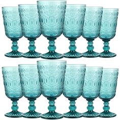 six blue glass goblets sitting next to each other