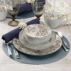 a place setting with blue and white dishes