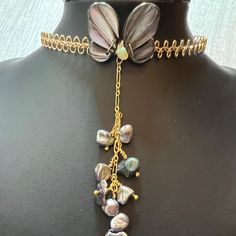 This is a beautiful one of a kind Mother of Pearl butterfly choker necklace with a pearl cluster pendant. The choker is made of a  gold wire scalloped lace design that is adjustable and will fit 14-16 inches. A shimmering dark grey carved mother of pearl butterfly wings are wrapped with 14K gold filled wire to the front of the choker. In between the two butterfly wings is a yellow nugget shaped Opal. A 3 inch length of gold figaro chain with clusters of Keshi pearls hang gently down the center o Pearl Cluster Necklace, Butterfly Choker, Lace Choker Necklace, Pearl Butterfly, Butterfly Necklace Gold, Opal Birthstone, Black Pearl Necklace, Necklace Opal, Lace Choker