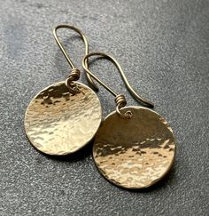 "14k gold filled hammered disk earrings.  14k gold filled earwires. You know when that enormous golden Harvest Moon is just starting to rise in the evening sky? What a truly awesome sight it is!! Hammered 14k gold filled disks--Harvest Moons! I know that these will end up being your new favorites! If you don't have a pair then you definitely NEED a pair! 5/8\" disk Hand fabricated by me in my studio" Adjustable Hammered 14k Gold Earrings, 14k Gold Hammered Round Disc Jewelry, Hammered Metal Circle Jewelry, Minimalist Hammered Round Disc Earrings, Gold Hammered Circle Earrings, Hand Forged 14k Gold-filled Round Earrings, Hammered Brass Round Disc Earrings, Earrings Dangle Simple, Simple Gold Earrings