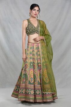 Multi color banarasi silk lehenga with all over Royal mahal woven details. Paired with a sleeveless V neck forest green blouse with floral embroidery using sequin, cutdana highlights and an organza dupatta with sequin work. - Aza Fashions Art Silk Choli With Meenakari Detailing, Art Silk Meenakari Choli, Silk Meenakari Choli For Reception, Silk Lehenga With Meenakari Detailing, Fitted Raw Silk Choli With Meenakari Details, Silk Lehenga With Pallu, Silk Pista Green Choli For Festivals, Pista Green Meenakari Lehenga, Green Lehenga With Motifs For Transitional Season