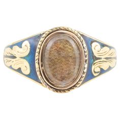 an old gold and blue ring with a stone in the center