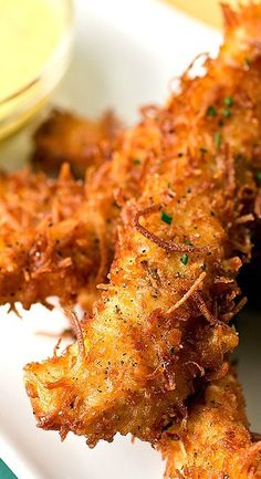 fried fish sticks with dipping sauce on the side