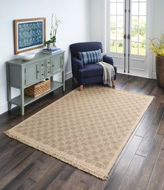 a living room with a blue chair and wooden floors