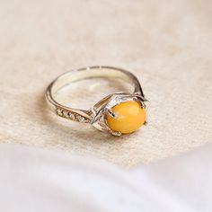 Natural Yellow Opal Women's Ring, Cabochon Oval Cut Ring Moissanite Pieces 925 Sterling Silver Ring For Women, Handmade Ring, Women's Ring. This exquisite women's ring features a captivating natural yellow opal, elegantly cut into a smooth cabochon oval and set in high-quality 925 sterling silver. Enhanced by the brilliance of moissanite accents, this ring is a true statement piece that combines timeless elegance with modern sophistication. Ring Features: Gemstones: Yellow Opal: The centerpiece of the ring is a stunning yellow opal, cut into an oval cabochon. Known for its warm, golden hues and gentle play of light, the opal exudes a soft, radiant glow that captures the eye and evokes a sense of serenity and joy. Moissanite Accents: Surrounding the central opal are sparkling moissanite pie Oval Cabochon Citrine Rings, Yellow Oval Cabochon Gemstone Ring, Amber Cabochon Ring For Anniversary, Yellow Oval Cabochon Ring For Gift, Yellow Cabochon Rings For Anniversary, Amber Sterling Silver Oval Cabochon Ring, Amber Sterling Silver Ring With Oval Cabochon, Amber Oval Cabochon Sterling Silver Ring, Oval Cut Ring