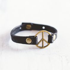 Our Peacemaker bracelet was inspired by the powerful meaning behind it. It represents taking action to reach for unity and understanding, so it's no surprise it's one of our most popular styles. Our Peacemaker Bracelet is handcrafted with the softest lamb leather and detailed with antique brass flat rivets. This bracelet can be worn alone or stacked with your favorite Giving Bracelet! FEATURES Handcrafted - Each Bracelet is delicately handcrafted. Finest Leather Available - We use lamb leather t Peace Maker, Pineapple Leather, Antique Brass Lighting, Taking Action, Brass Bracelet, Summer Bracelets, Great Words, Boho Look, Peace Sign