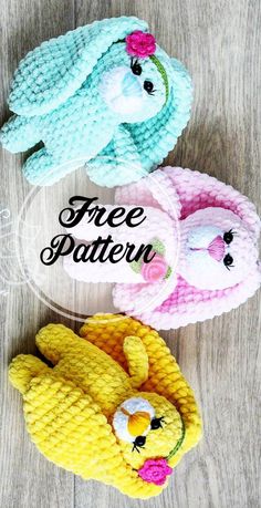 three crocheted stuffed animals sitting next to each other on top of a wooden table