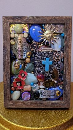 a small wooden box filled with lots of different types of glass and metal items on top of a table