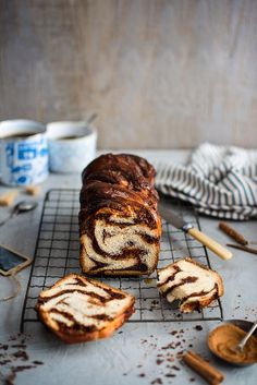 a loaf of cinnamon swirl bread on a cooling rack