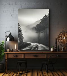 a table with two chairs and a painting on the wall in front of it, next to a lamp