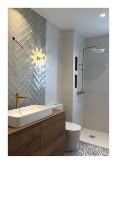 a modern bathroom with herringbone tile on the wall and wood cabinetry, along with a white toilet