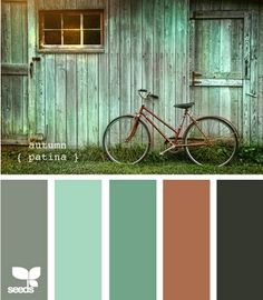 a bike parked in front of a wooden building with lots of green and brown colors