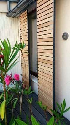 the door is open and there are pink flowers in bloom on the outside deck area