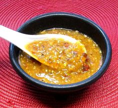 a bowl filled with soup on top of a red place mat