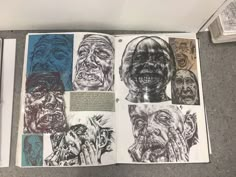 an open book with drawings on the pages and pictures of people's faces in different colors