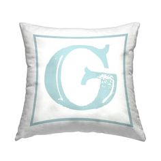 a white and blue pillow with the letter g on it