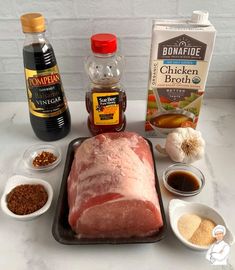 ingredients to make chicken broth laid out on a counter top with meat and spices