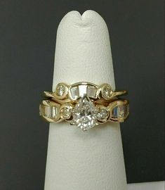 a gold ring with two diamonds on it