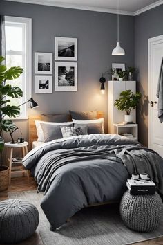 a bedroom with grey walls and bedding in the corner, potted plants on the floor