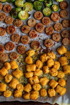 an overhead view of different types of appetizers and brussels sprouts on a baking sheet