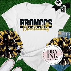 the bronco's celebrating shirt with gold and black pom poms