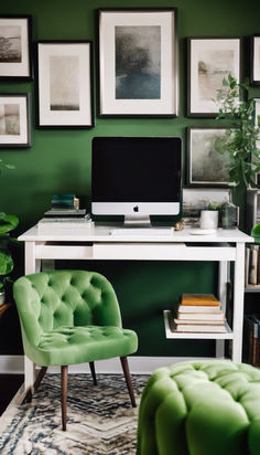 a desk with a computer, chair and pictures on the wall above it in a green room