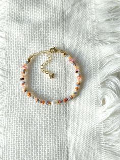 FOR OTHER DAINTY BEADED BRACELETS: https://www.etsy.com/ca/shop/ArtiChouXCanada?ref=seller-platform-mcnav%C2%A7ion_id§ion_id=46088511 Bracelet Length: 13-18cm (5.1-7 inches) with a 14k gold filled or sterling silver extender. This bracelet features a variety of stunning fall pastel colors: orange, brown, pink, cream, white, blue, and 18k gold filled seed beads. It also contains a freshwater pearl.  Thread may be visible since it is a handmade product   SIZING  Wrap a soft measuring tape snugly around the widest part of your wrist. Add 1.27cm (0.5in) to that measurement to determine the right bracelet size.  MATERIALS  - Japanese MGB glass seed beads(2x4mm) - 18K gold filled or sterling silver beads of 2mm - Freshwater pearl - 14K gold filled or sterling silver extender  CARE INSTRUCTIONS Bohemian Multicolor Adjustable Pearl Bracelet, Bohemian Pearl Bracelet With Colorful Beads And Adjustable Fit, Bohemian Adjustable Pearl Bracelet With Colorful Beads, Adjustable Bohemian Pearl Bracelet With Colorful Beads, Adjustable Multicolor Hand-strung Pearl Bracelet, Adjustable Hand-strung Multicolor Pearl Bracelet, Adjustable Multicolor Pearl Bracelet With Colorful Beads, Multicolor Dainty Beaded Bracelets, Dainty Multicolor Beaded Bracelets For Beach