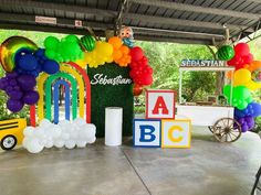 an outdoor birthday party with balloons and decorations