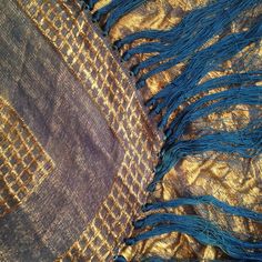 "This is an extraordinarily beautiful 1920's Art Deco rich blue lapis and gold lamé shawl in an abstract design, so indicative of the period. The shawl measures 47\" square, excluding its 13\" silk fringe which surround each of its four sides. In excellent vintage condition and would make the perfect accessory for any special occasion. Made of silk and metallic thread. Vintage garments have been previously worn and lovingly cared for, they may however have a blemish or two. Here at MadelonVintag Blue Festival Shawl Dupatta, Festival Blue Shawl Dupatta, Gold Bohemian Shawl For Festive Occasions, Bohemian Gold Shawl For Festive Occasions, Blue Shawl Dupatta For Festivals, Blue Dupatta Shawl For Festivals, Blue Bohemian Shawl With Traditional Drape, Blue Bohemian Shawl For Festivals, Bohemian Gold Shawl Scarves