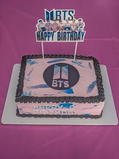 a birthday cake with the bts logo on it