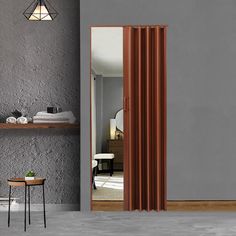 a room with a gray wall and brown curtains