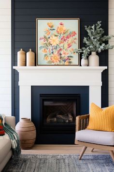 a living room filled with furniture and a painting on the wall above a fire place