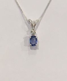 Genuine small oval shaped A quality ( light bluish purple to medium bluish purple depending on the light) tanzanite measures 6x4mm (1/2 carat). Genuine 2mm accent diamond. Both handset in sterling silver. Sterling silver box chain is 18 inches long and can be switched out to a 16 inch chain upon request. Necklace is perfect for a child or the minimalist. Comes in a gift box Ruby Heart Necklace, Purple Stone Necklace, Smoky Quartz Jewelry, February Birthstone Necklace, Smoky Quartz Necklace, Bluish Purple, Smoky Quartz Pendant, Tanzanite Diamond, Topaz Jewelry