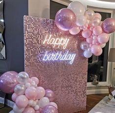 a birthday party with pink and white balloons