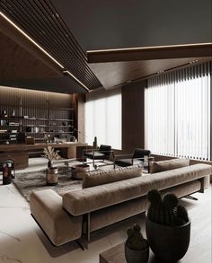 a living room with couches, tables and bookshelves on the wall in front of large windows