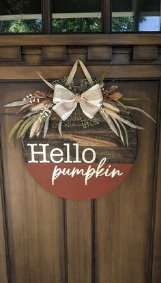 a wooden door with a sign that says hello pumpkin