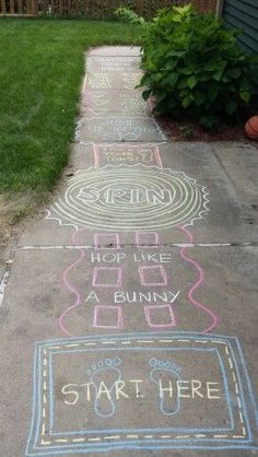 some chalk drawings on the sidewalk in front of a house