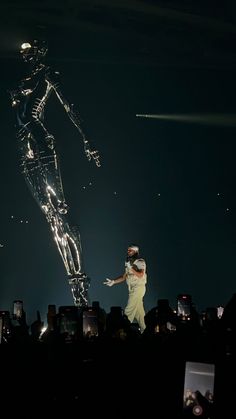 a man standing on top of a stage next to a woman in front of a crowd